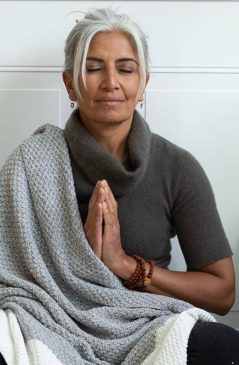 a gray hair lady is meditating